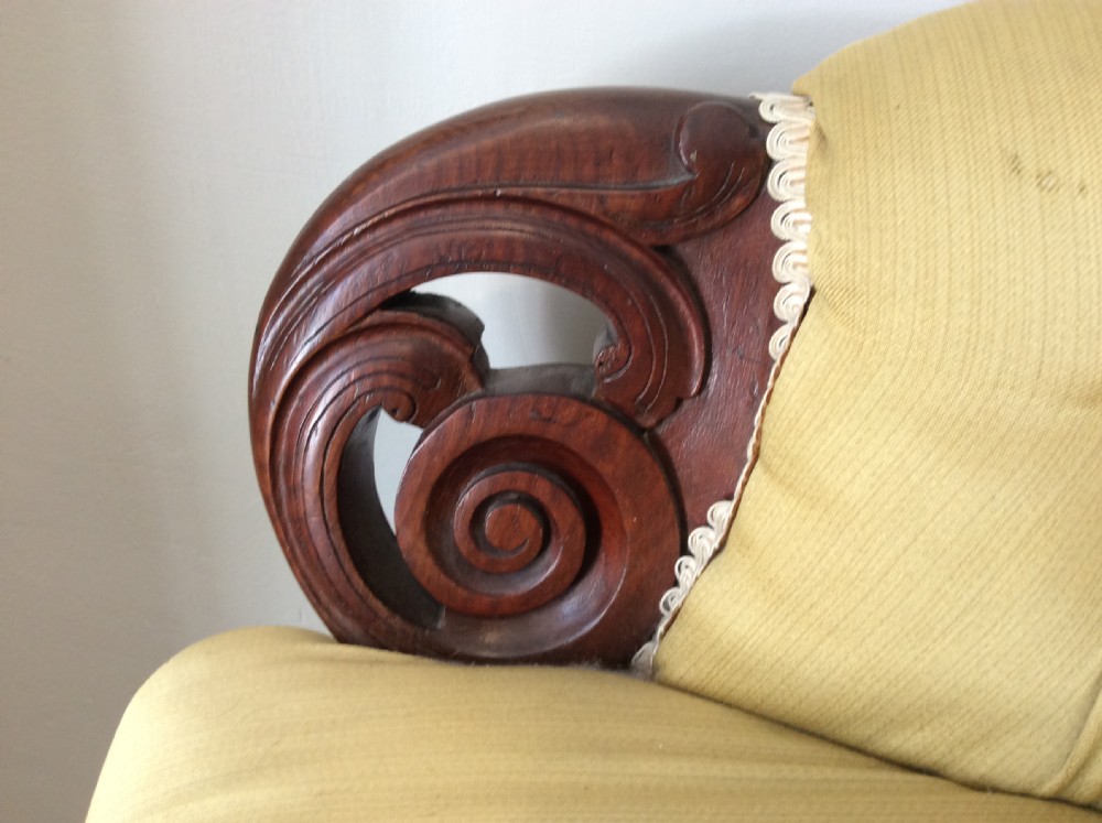 A near pair of Victorian button-backed tub armchairs upholstered in yellow fabric with carved mahogany cabriole legs on castors. View VII