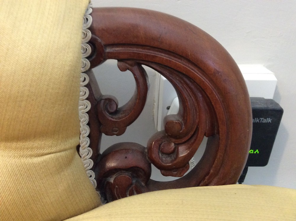 A near pair of Victorian button-backed tub armchairs upholstered in yellow fabric with carved mahogany cabriole legs on castors. View VIII