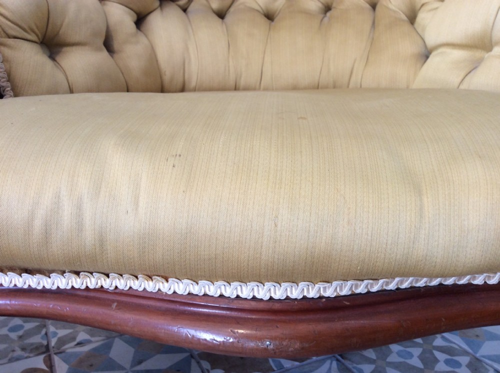 A near pair of Victorian button-backed tub armchairs upholstered in yellow fabric with carved mahogany cabriole legs on castors. View XV