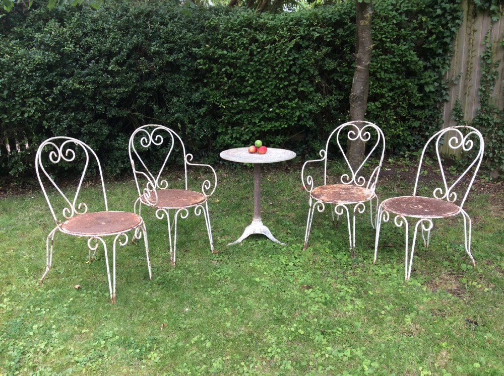 A table together with set of French iron garden chairs 