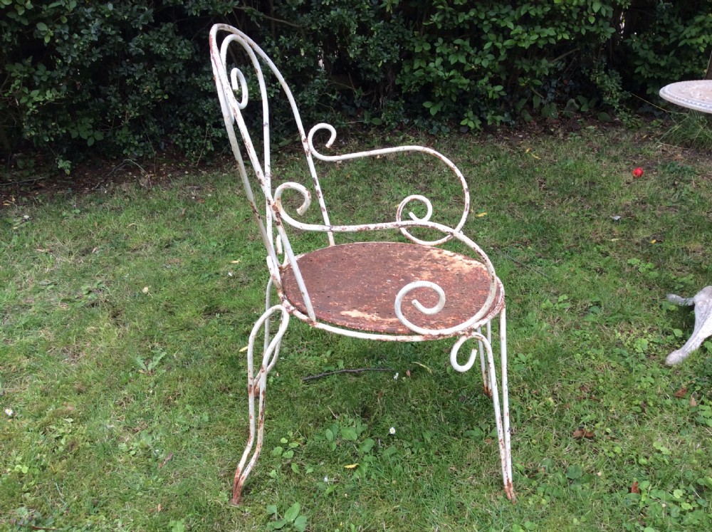 A table together with set of French iron garden chairs  View III