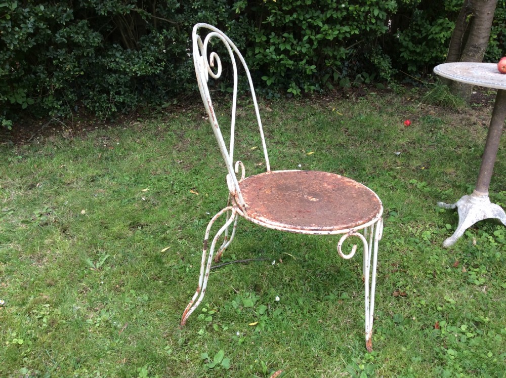 A table together with set of French iron garden chairs  View IV