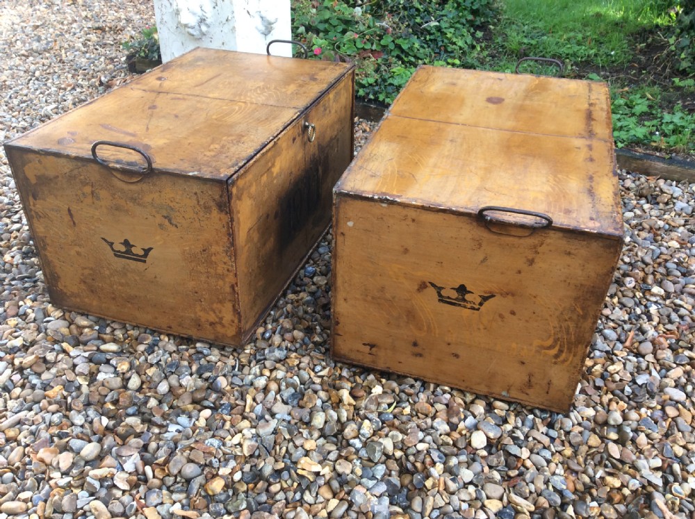 A pair of rectangular Victorian deed boxes finished in warm ochre paint with dark metal edging, ring pull handles, and black stencilled dates reading 1891 and 1911. View VI