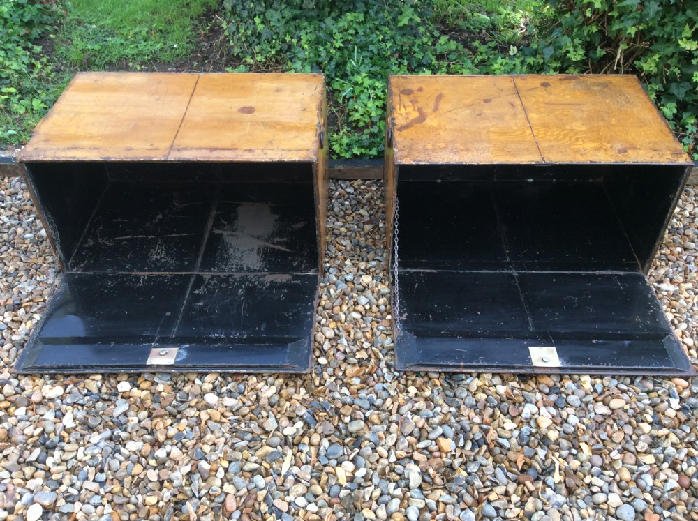 A pair of rectangular Victorian deed boxes finished in warm ochre paint with dark metal edging, ring pull handles, and black stencilled dates reading 1891 and 1911. View X
