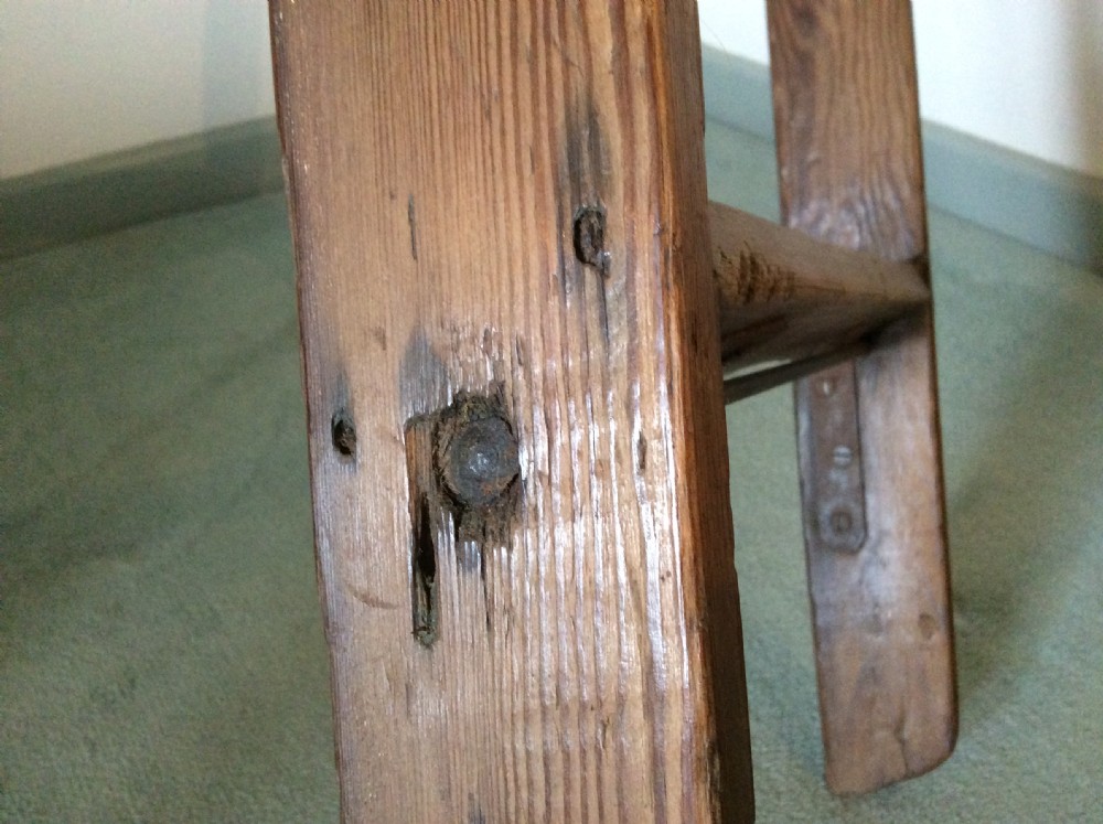 A tall Victorian pine shop ladder featuring straight wooden stiles, flat horizontal rungs, and a top mounting bar. View VIII
