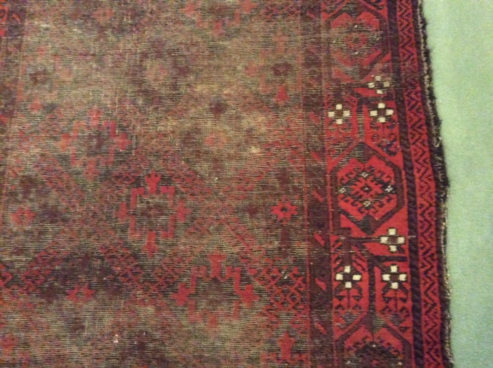 A well worn antique Afgan Baluch rug View IX