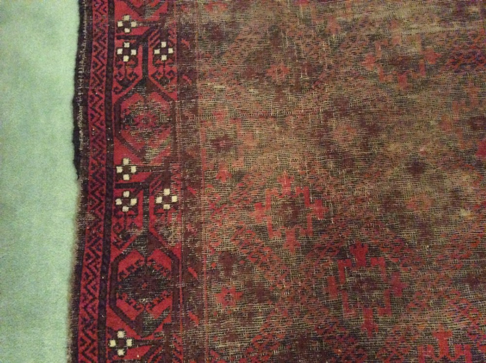 A well worn antique Afgan Baluch rug View X