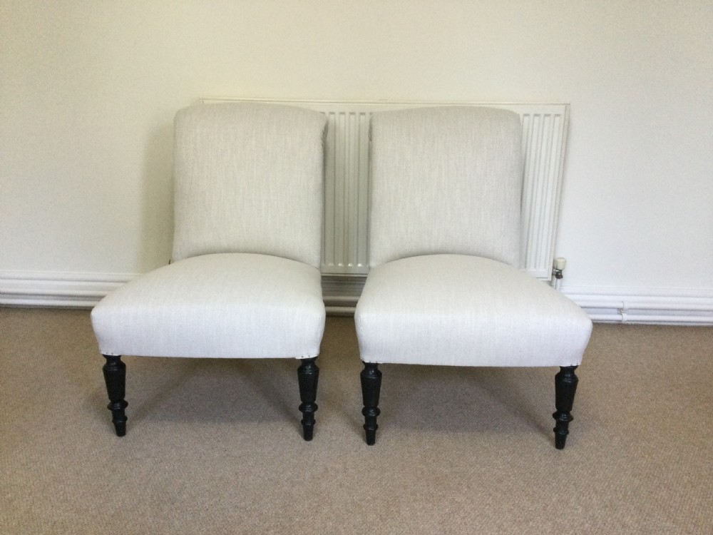 A pair of Napoleon III scroll back chairs