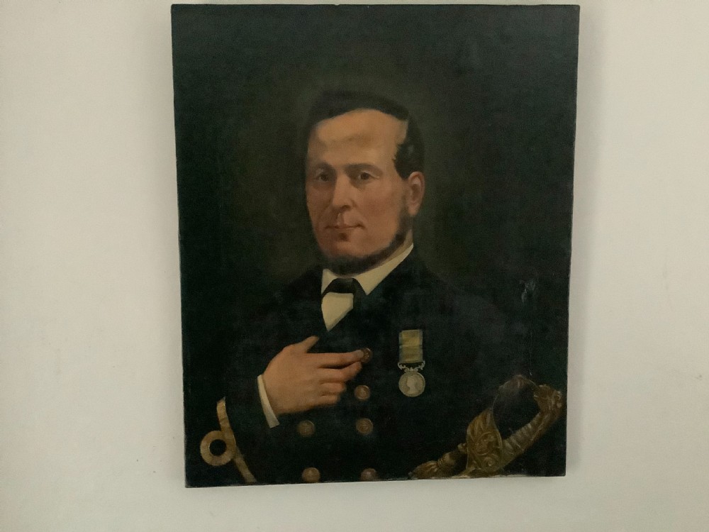 An antique oil painting on canvas depicting a Victorian naval officer in a dark double-breasted uniform with a chest medal and sword hilt.