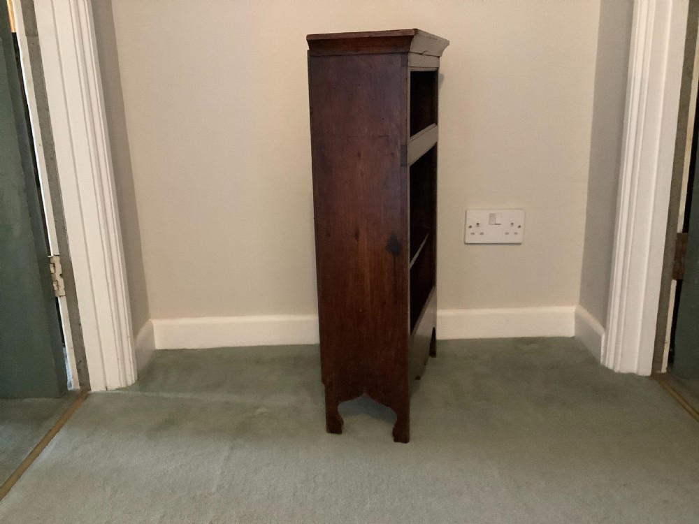 A small dark wood open French dwarf bookcase featuring three shelf tiers, a top moulded cornice, and a scalloped base apron. View III