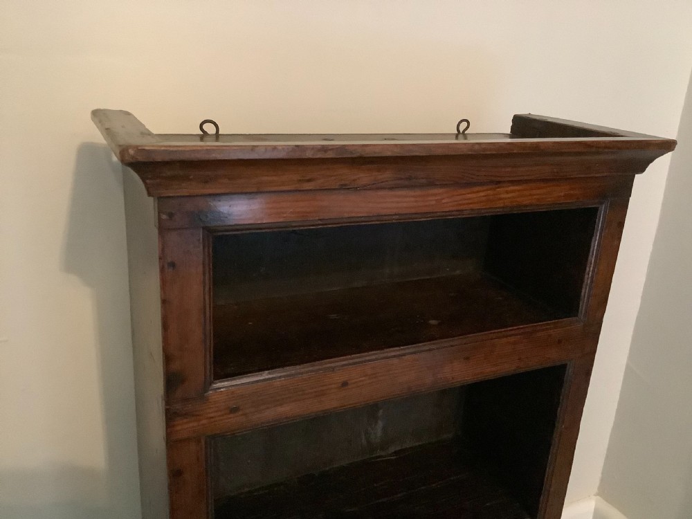 A small dark wood open French dwarf bookcase featuring three shelf tiers, a top moulded cornice, and a scalloped base apron. View VI