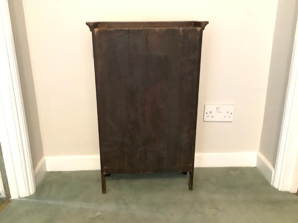 A small dark wood open French dwarf bookcase featuring three shelf tiers, a top moulded cornice, and a scalloped base apron. View IX