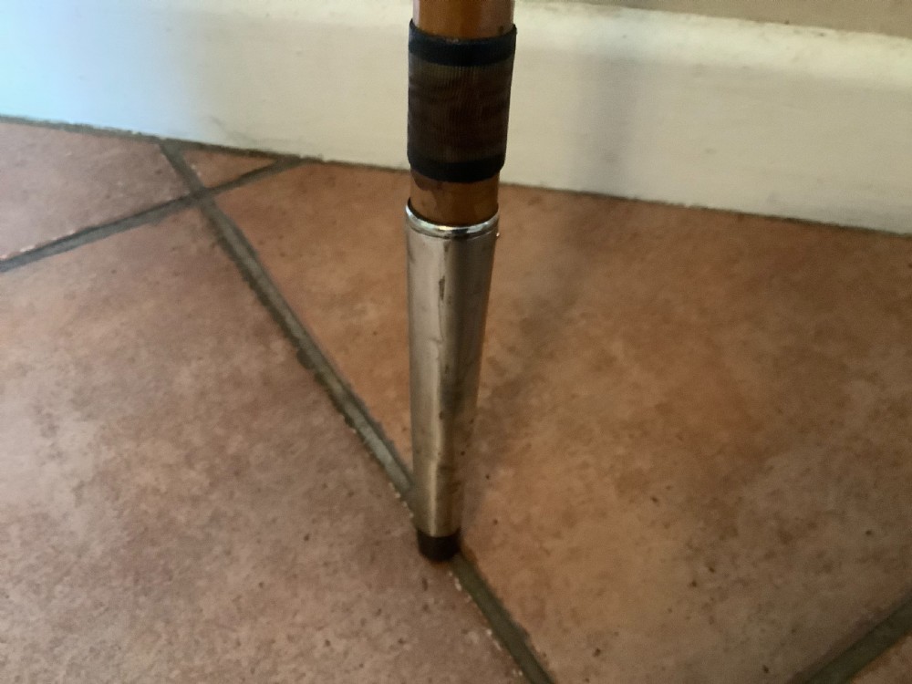 A wooden walking cane featuring a swirl-fluted hallmarked silver pommel top and silver collar. View IV