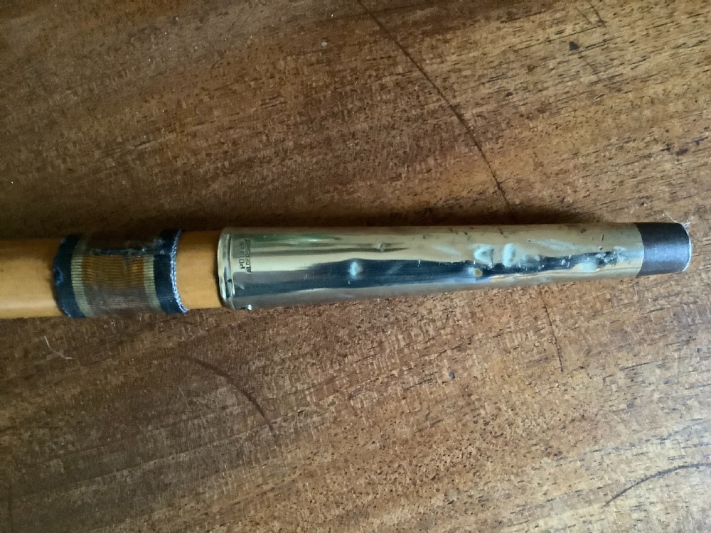 A wooden walking cane featuring a swirl-fluted hallmarked silver pommel top and silver collar. View VII
