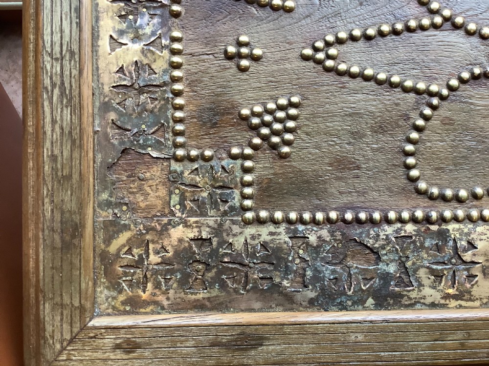 A nineteenth-century wooden Zanzibar storage chest decorated with intricate brass studs, pierced metal plates, three lower drawers, and brass handles. View XII