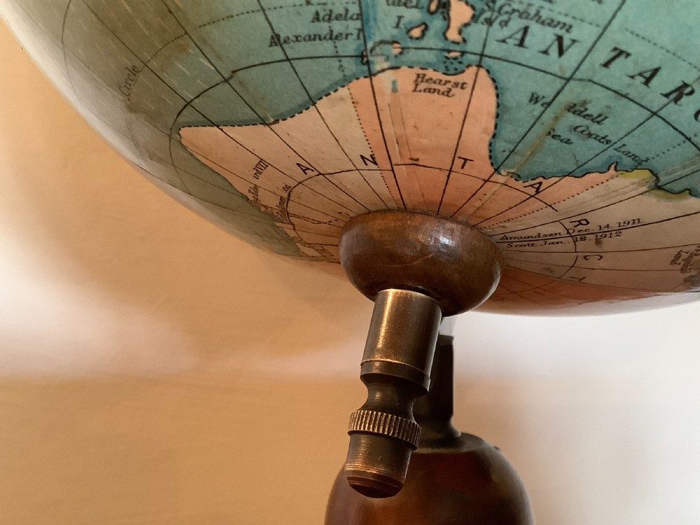 An antique terrestrial desk globe featuring printed paper gores, a brass semi-meridian arc, and a dark turned wooden base. View VI