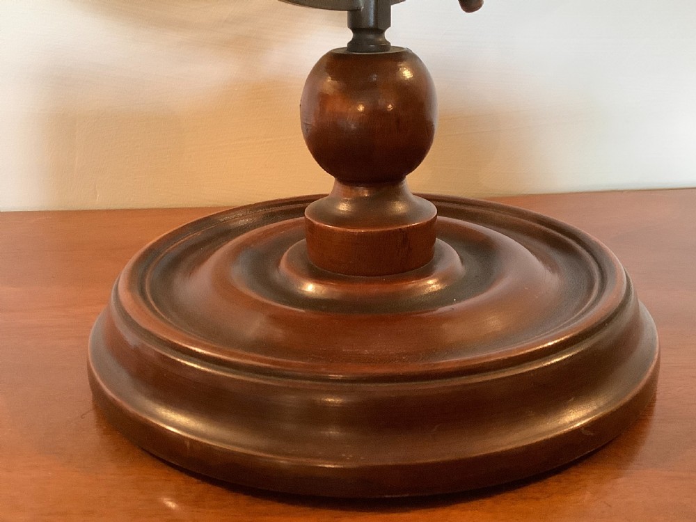 An antique terrestrial desk globe featuring printed paper gores, a brass semi-meridian arc, and a dark turned wooden base. View XI