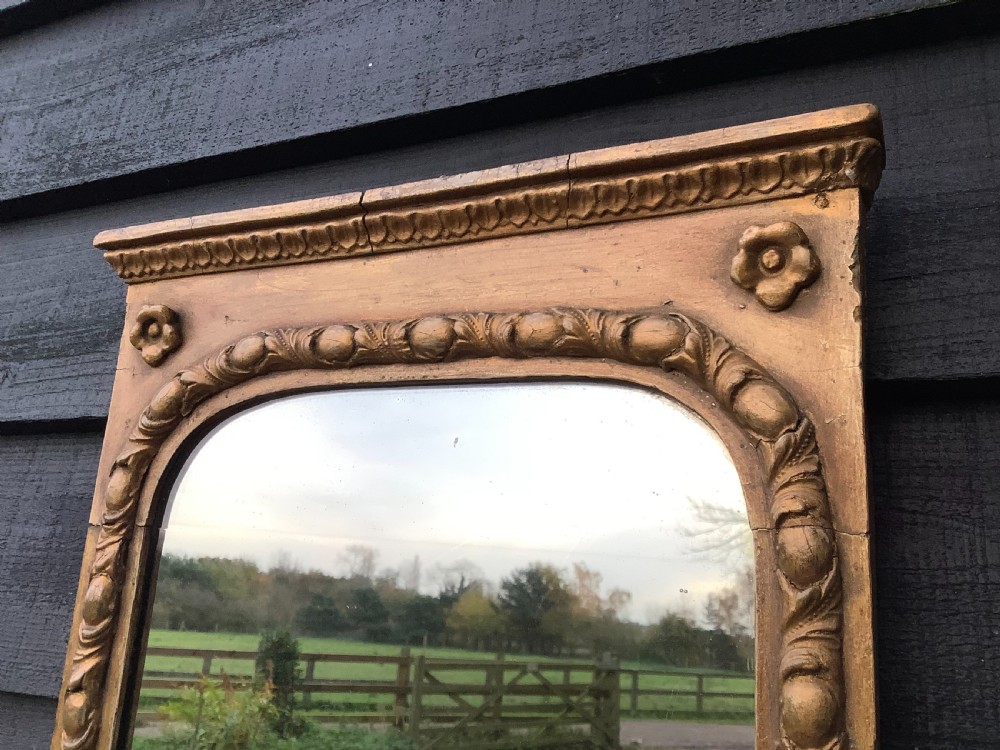 A tall rectangular giltwood pier mirror featuring an arched inner frame, carved classical mouldings, and two attached double-branch candle sconces. View IV