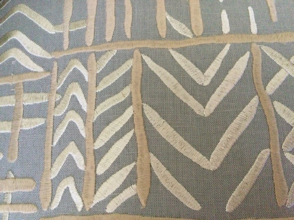 A 19th-century French armchair re-upholstered in a grey and white geometric patterned fabric with dark turned wood front legs on castors. View VI