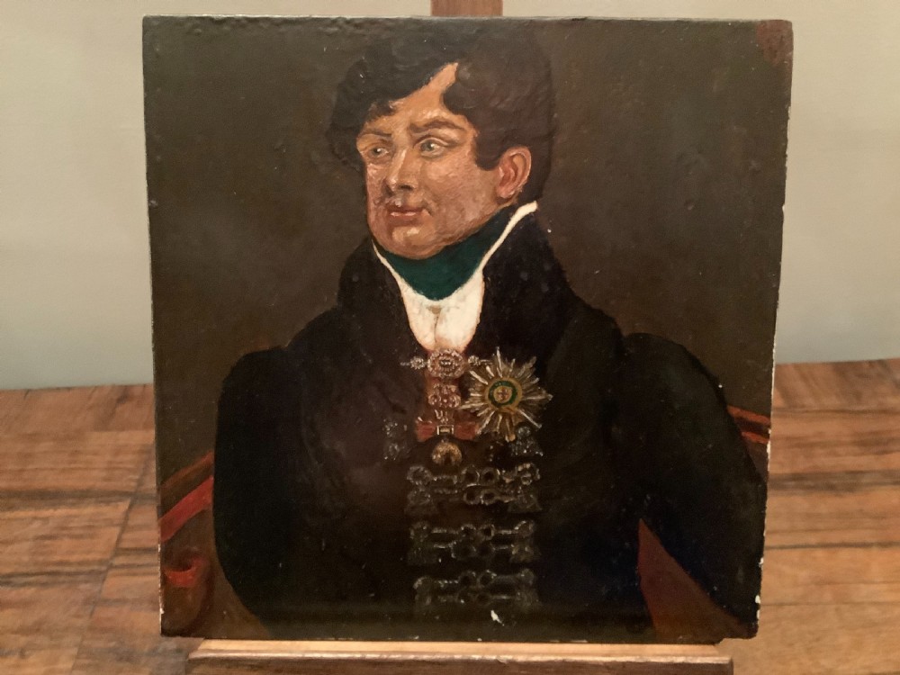 A small square Regency oil portrait painting depicting King George IV in a dark double-breasted coat adorned with military decorations.