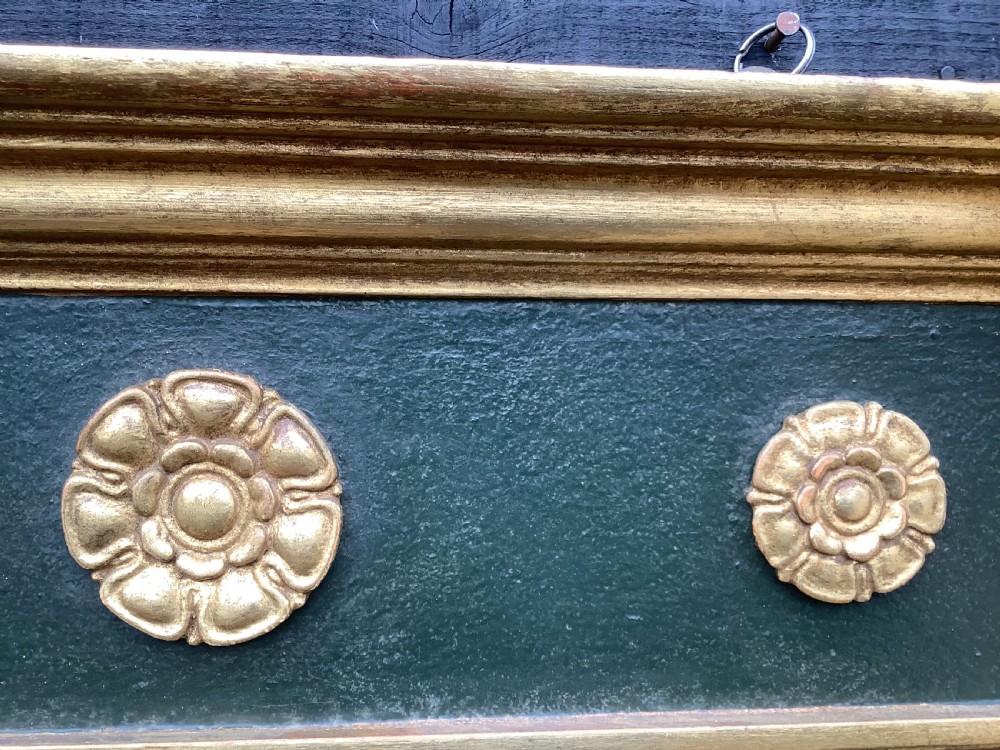 A 19th-century giltwood triple plate overmantel mirror featuring spiral-twist side columns, a dark painted frieze with gold rosettes, and a central carved shell motif. View X