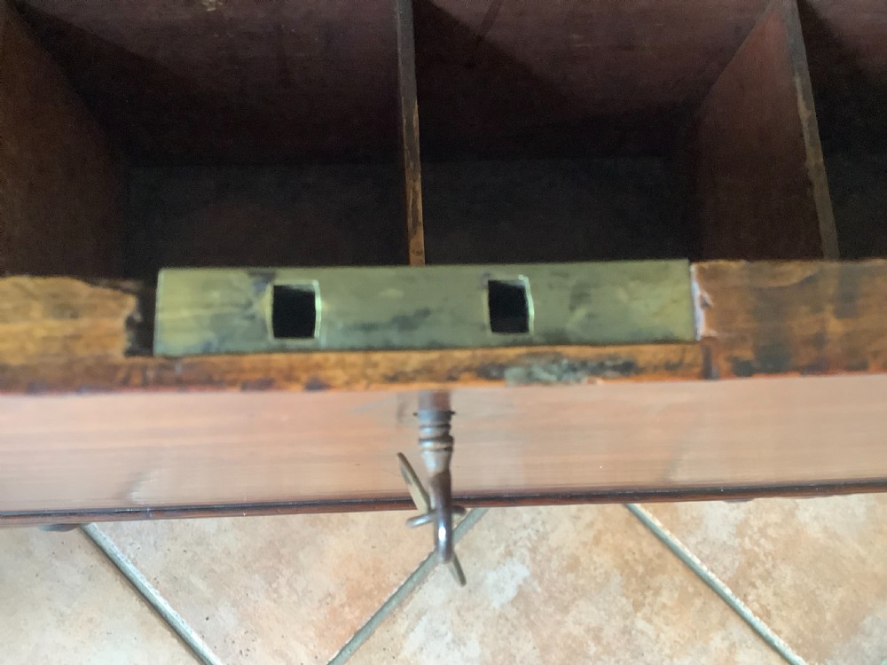 A Georgian mahogany cellarette featuring a domed lid, turned legs, flame mahogany wood grain, and side brass handles. View IX