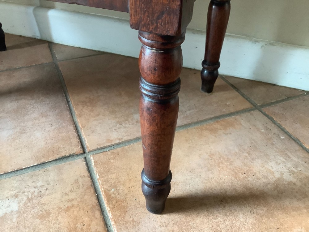 A Georgian mahogany cellarette featuring a domed lid, turned legs, flame mahogany wood grain, and side brass handles. View XII