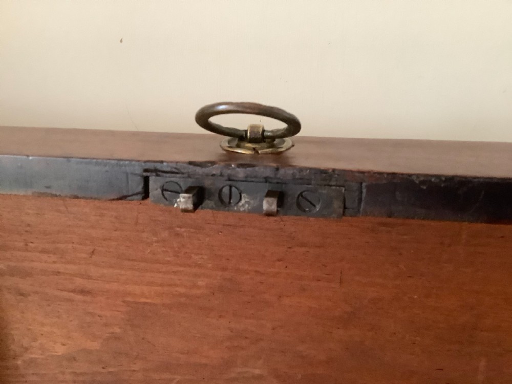 A Georgian mahogany cellarette featuring a domed lid, turned legs, flame mahogany wood grain, and side brass handles. View XIII