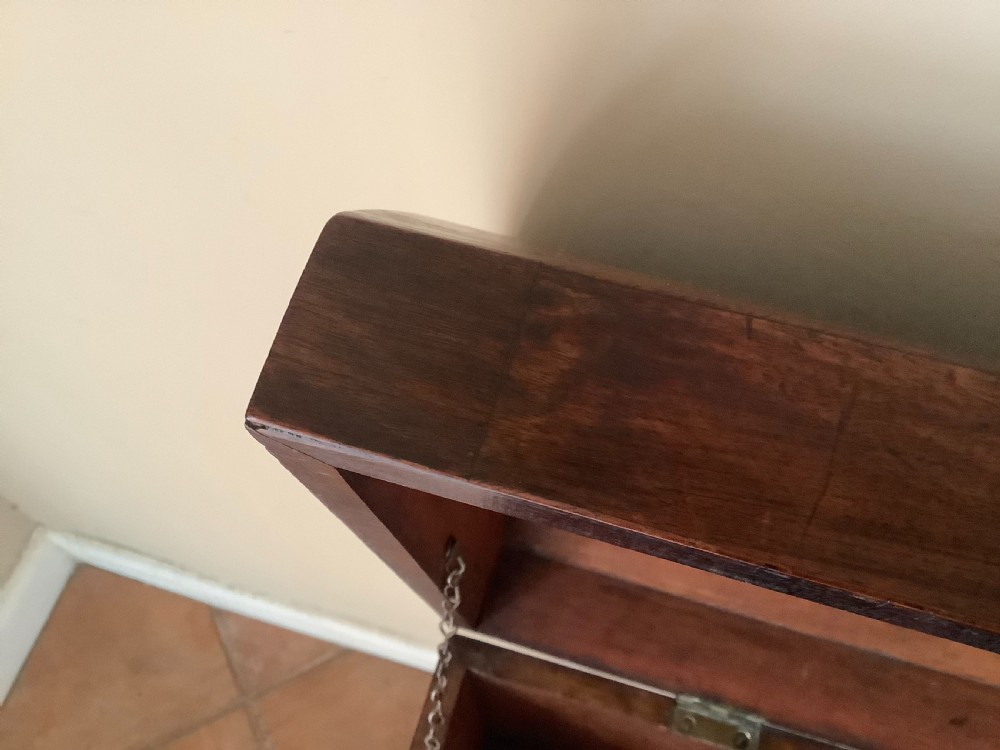 A Georgian mahogany cellarette featuring a domed lid, turned legs, flame mahogany wood grain, and side brass handles. View XIV