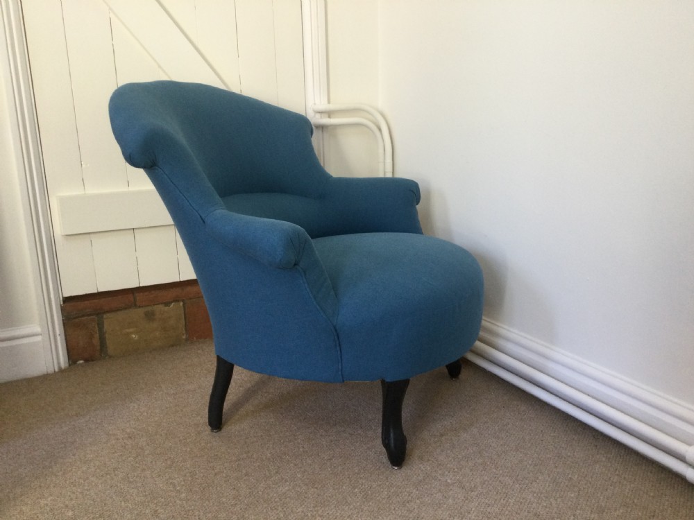 A 19th-century French crapaud armchair upholstered in teal blue fabric with dark wooden legs. View IV