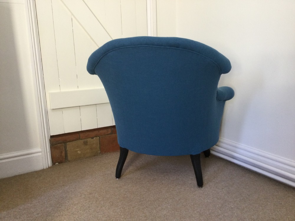 A 19th-century French crapaud armchair upholstered in teal blue fabric with dark wooden legs. View V