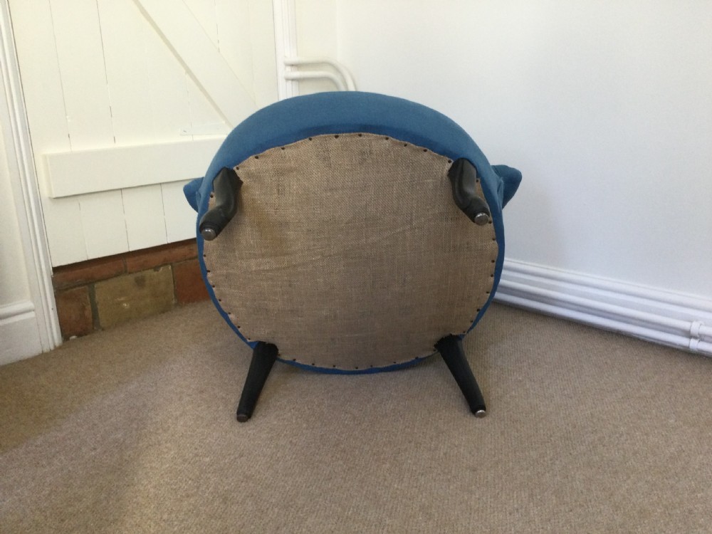 A 19th-century French crapaud armchair upholstered in teal blue fabric with dark wooden legs. View VI