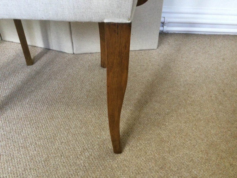 A pair of French Art Deco bridge chairs featuring curved wooden arms and light beige fabric upholstery. View VI