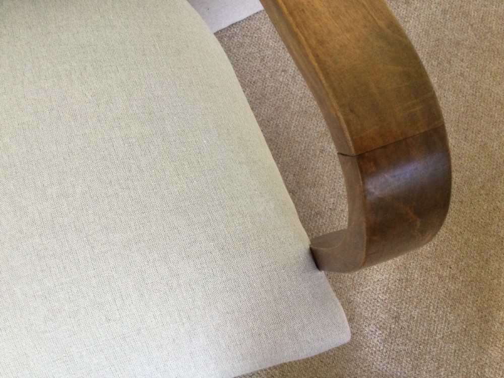 A pair of French Art Deco bridge chairs featuring curved wooden arms and light beige fabric upholstery. View VII
