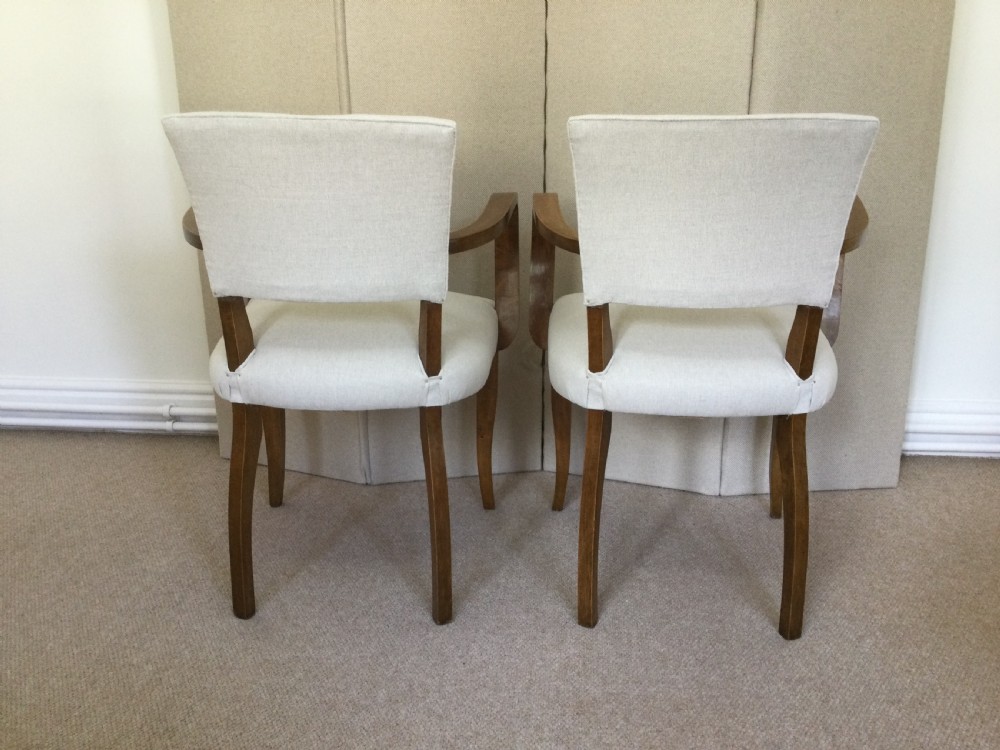 A pair of French Art Deco bridge chairs featuring curved wooden arms and light beige fabric upholstery. View VIII