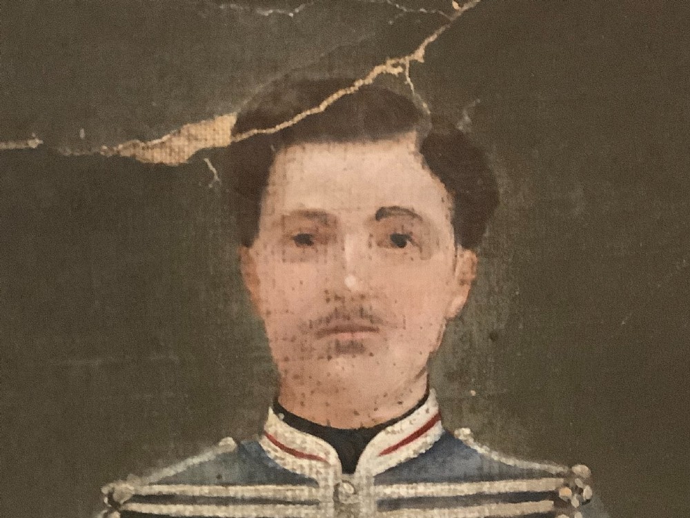 An antique full-length oil painting on canvas depicting a Hussar military officer standing in a braided blue uniform beside a pedestal. View II