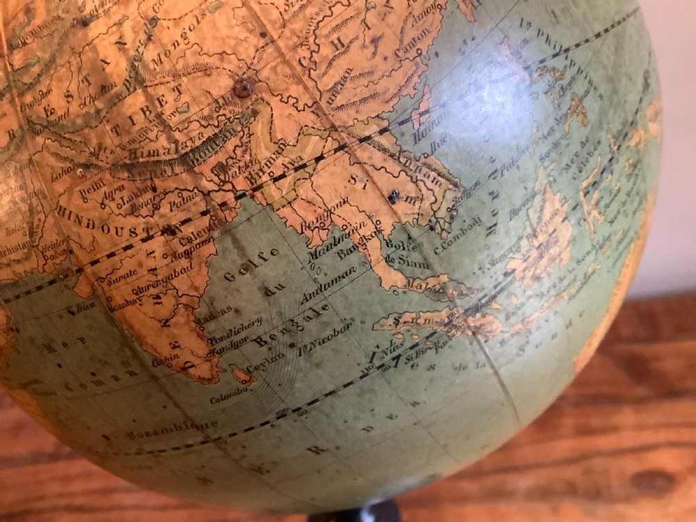 A small 19th-century French terrestrial globe with green oceans, mounted on a turned ebonised wood stand with brass fittings. View V