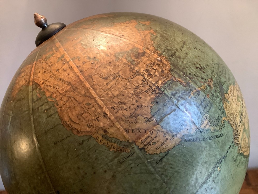 A small 19th-century French terrestrial globe with green oceans, mounted on a turned ebonised wood stand with brass fittings. View VII