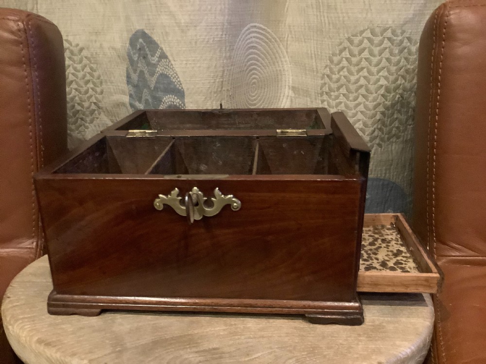 A rectangular Georgian mahogany tea caddy featuring a hinged lid, a brass top carrying handle, and an ornate brass keyhole escutcheon. View II
