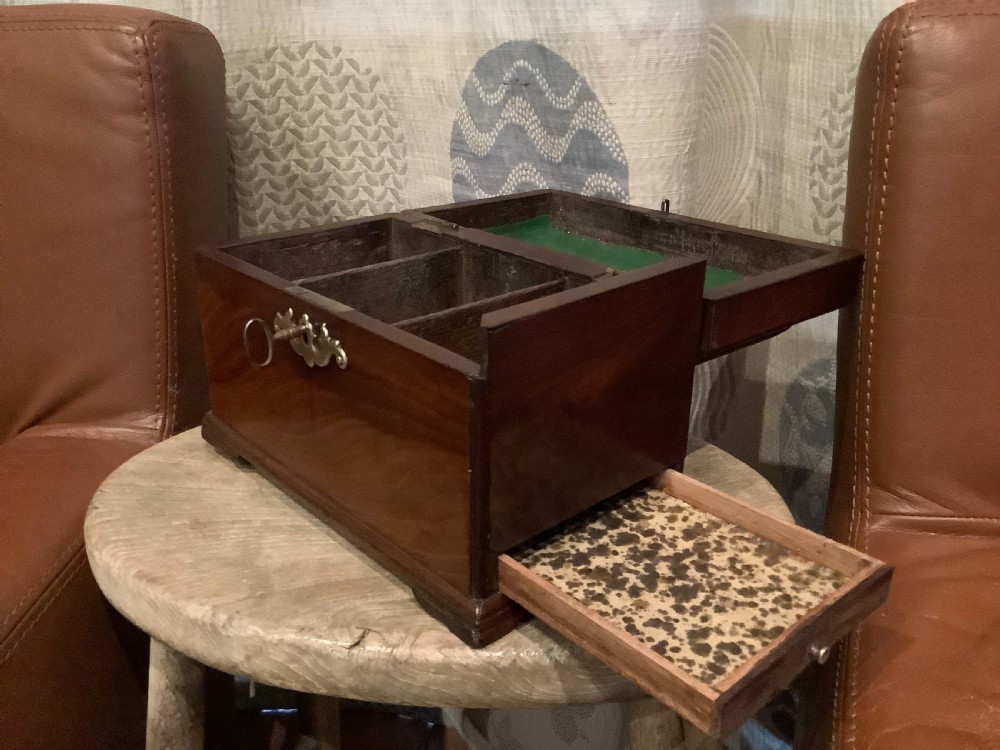 A rectangular Georgian mahogany tea caddy featuring a hinged lid, a brass top carrying handle, and an ornate brass keyhole escutcheon. View III