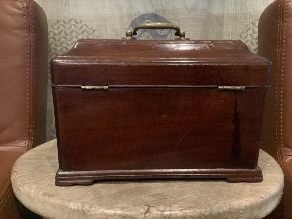 A rectangular Georgian mahogany tea caddy featuring a hinged lid, a brass top carrying handle, and an ornate brass keyhole escutcheon. View VII