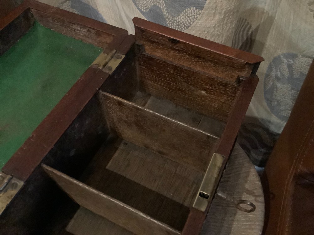 A rectangular Georgian mahogany tea caddy featuring a hinged lid, a brass top carrying handle, and an ornate brass keyhole escutcheon. View IX