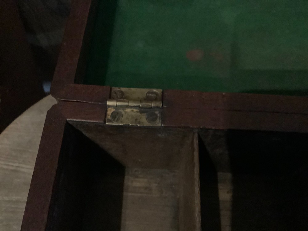 A rectangular Georgian mahogany tea caddy featuring a hinged lid, a brass top carrying handle, and an ornate brass keyhole escutcheon. View X