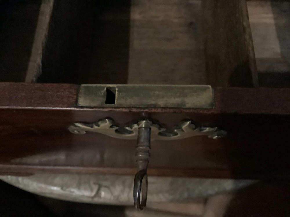 A rectangular Georgian mahogany tea caddy featuring a hinged lid, a brass top carrying handle, and an ornate brass keyhole escutcheon. View XI