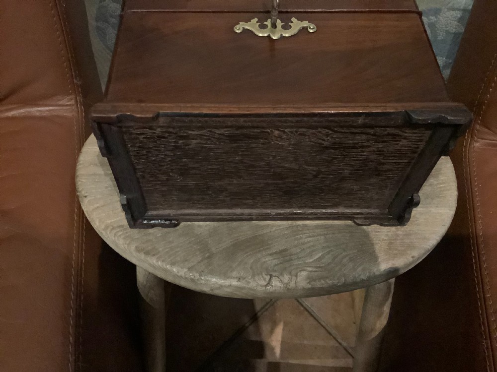 A rectangular Georgian mahogany tea caddy featuring a hinged lid, a brass top carrying handle, and an ornate brass keyhole escutcheon. View XII