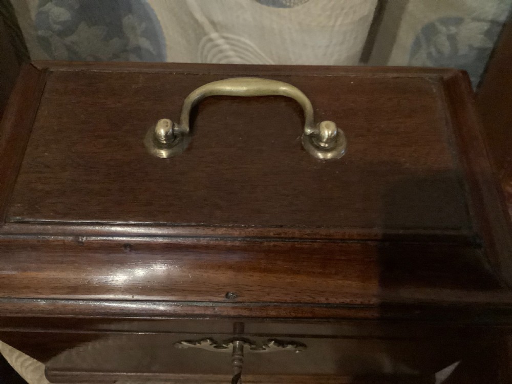 A rectangular Georgian mahogany tea caddy featuring a hinged lid, a brass top carrying handle, and an ornate brass keyhole escutcheon. View XIII