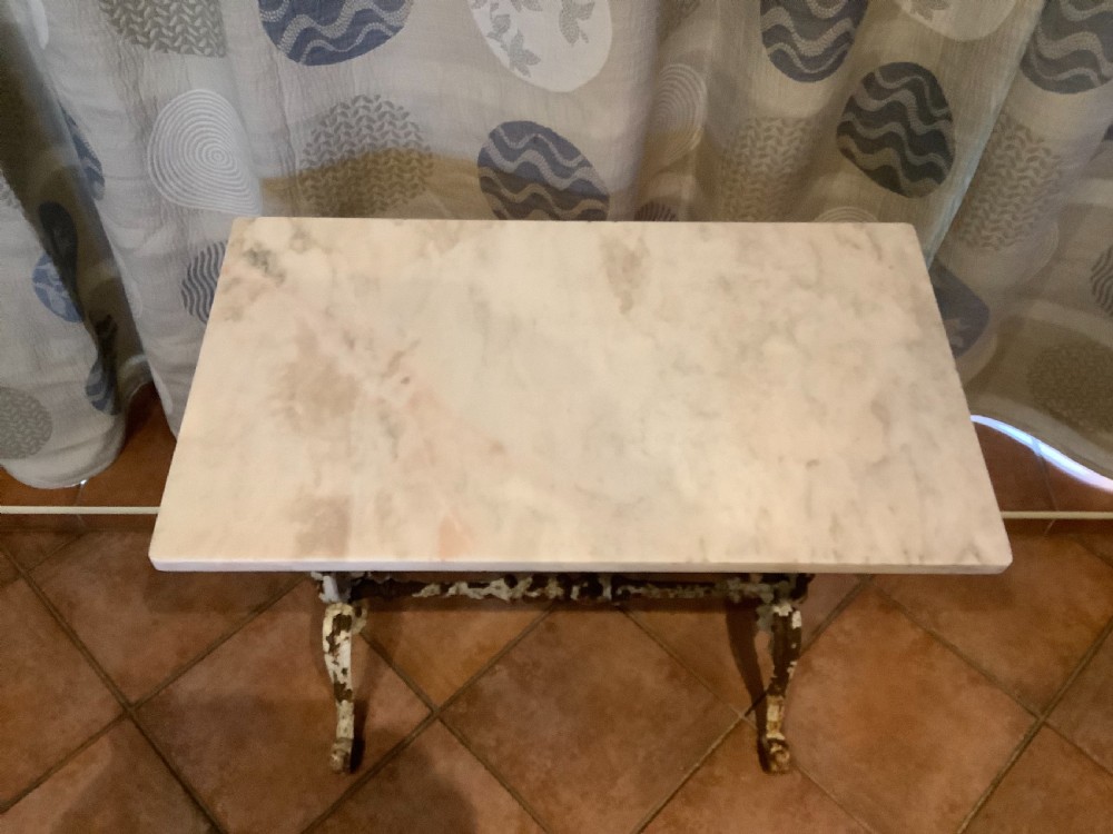 A nineteenth-century console table featuring a rectangular white marble top supported by a distressed white-painted cast iron base with ornate scrollwork. View IV