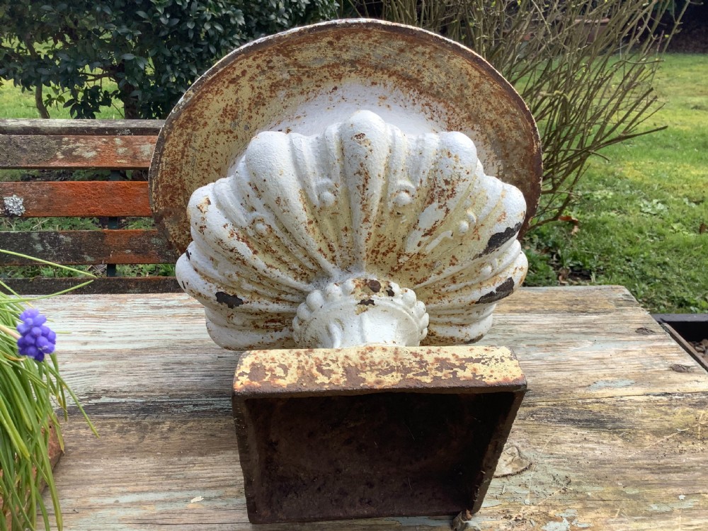 A pair of weathered off-white cast iron table urns featuring classical gadrooned decoration and square pedestal bases. View VIII
