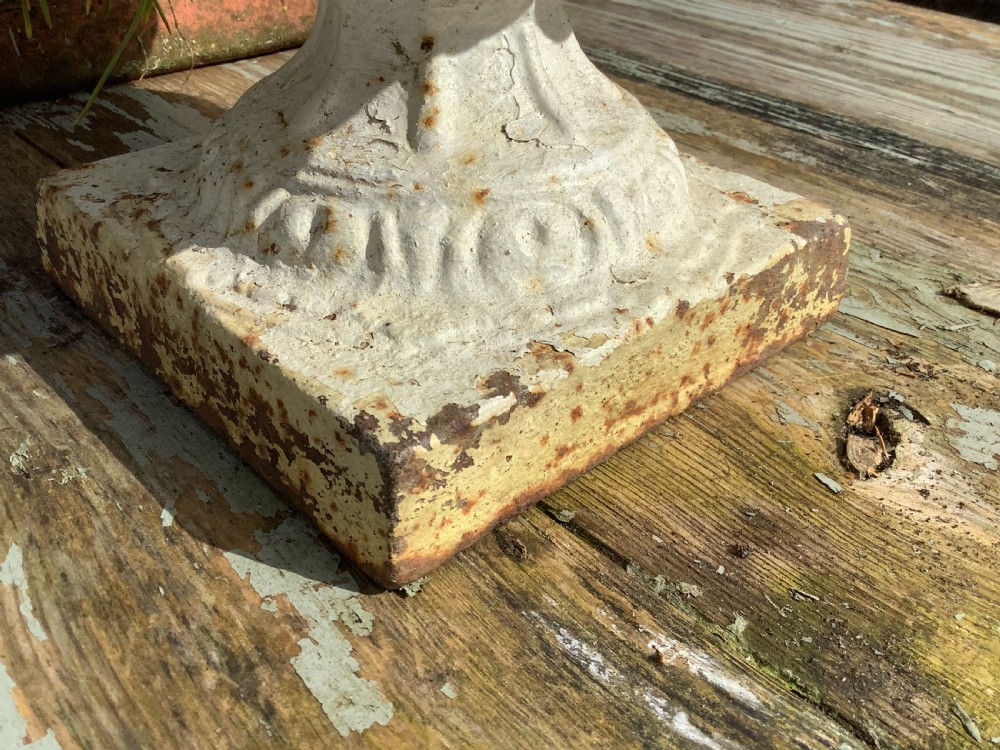 A pair of weathered off-white cast iron table urns featuring classical gadrooned decoration and square pedestal bases. View XII