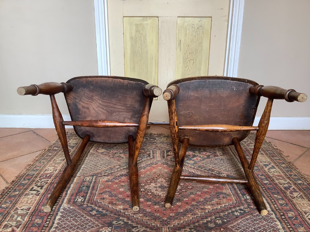 A near pair of antique wooden stick back Windsor kitchen chairs with hoop backs and turned legs. View VI
